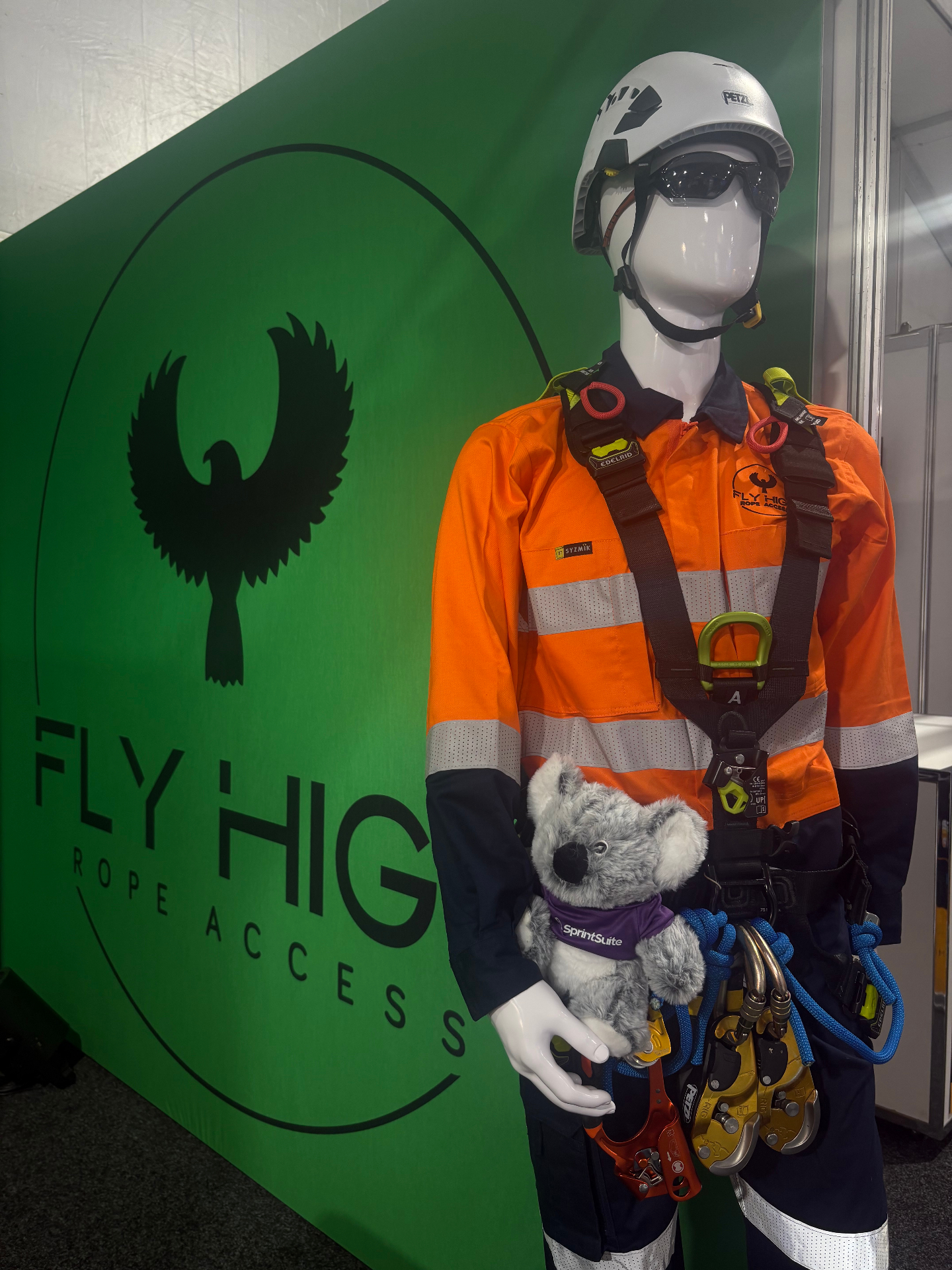 Bob the koala on a Fly High Rope Access harness display at QME 2026