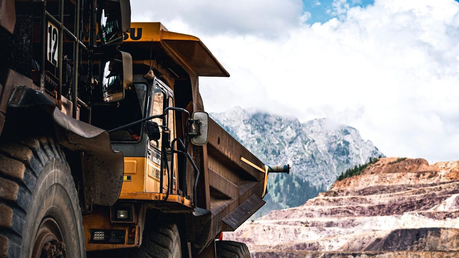 Australian mining engineer overlooking an open-pit mine at golden hour