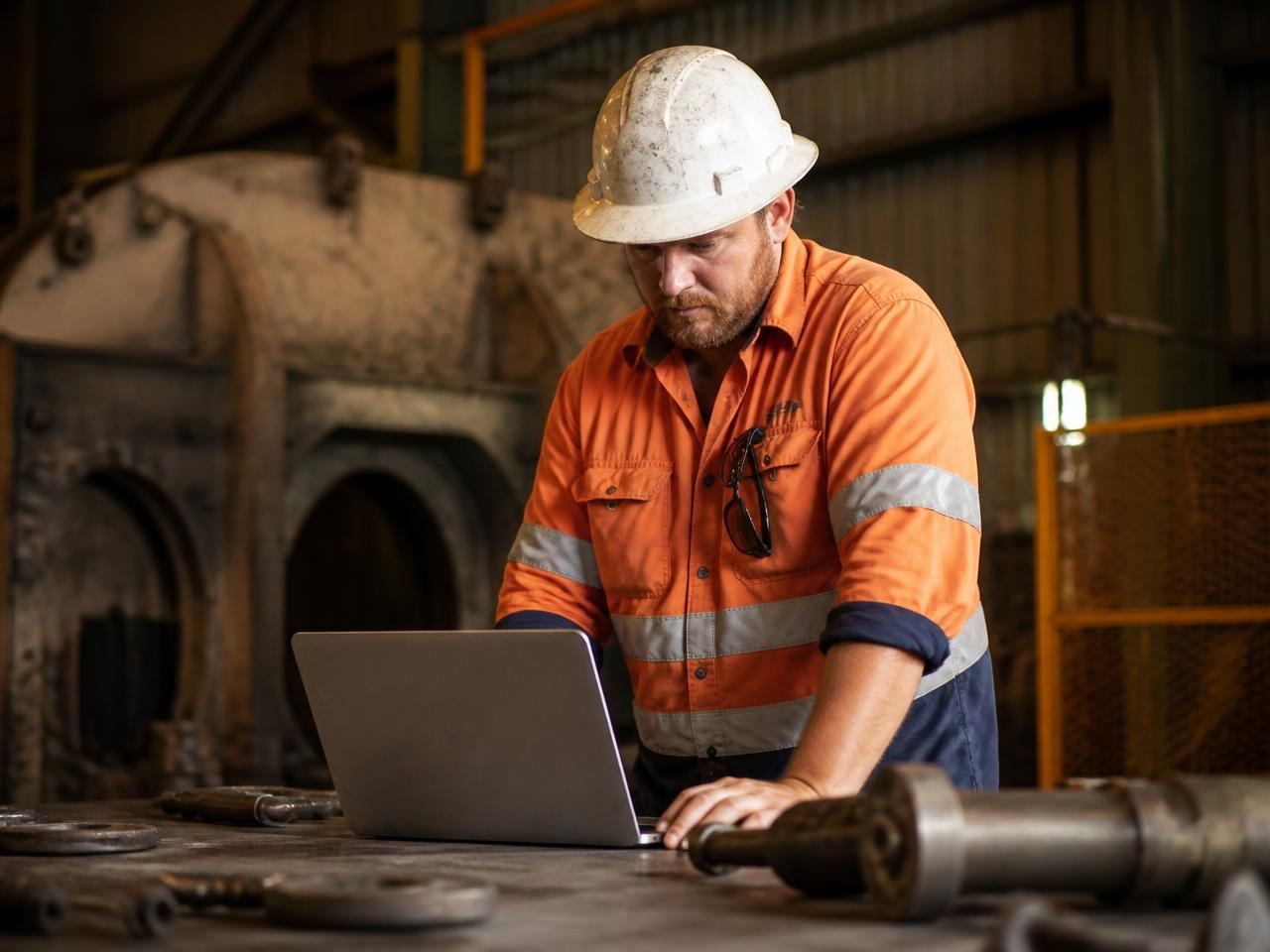Mining engineering supervisor reviewing job progress in job management software