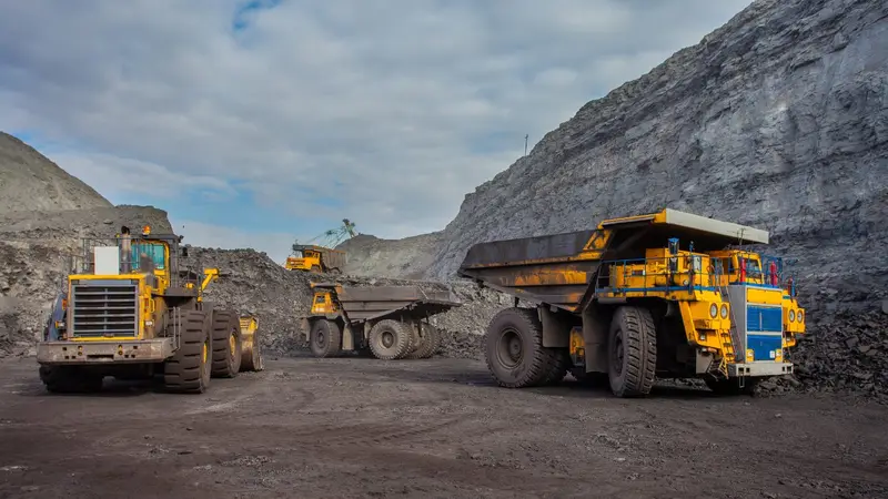 Mining supervisor reviewing compliance documents at site office